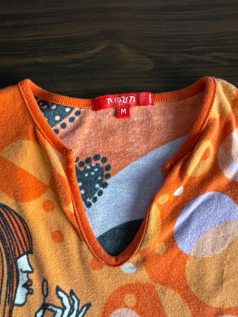 Retro Graphic V-Neck Women’s Top in Orange by - Picture 3 of 5